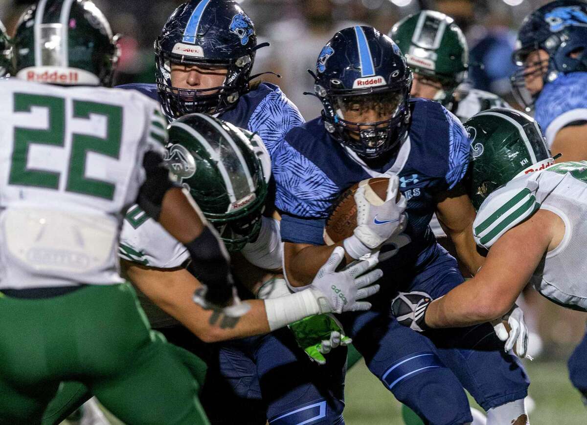 Johnson running back Ben McCreary breaks through the line Friday, Oct. 29, 2021 at Heroes Stadium during the Jaguars?• game against Reagan The Jaguars beat the Rattlers 46-43 in overtime.