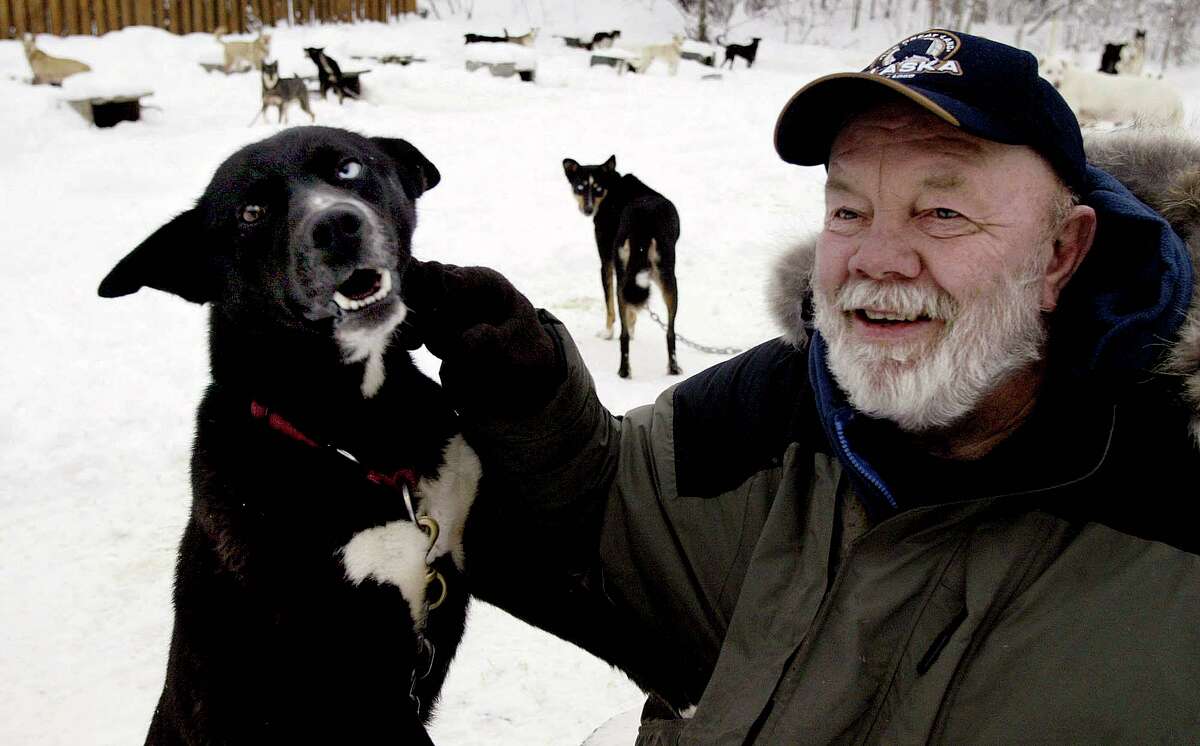 Author Gary Paulsen sits with his favorite Alaskan husky, Flax, at his Willow, Alaska, home on Feb. 10, 2005. Paulsen died Wednesday, Oct. 13, 2021 at age 82.