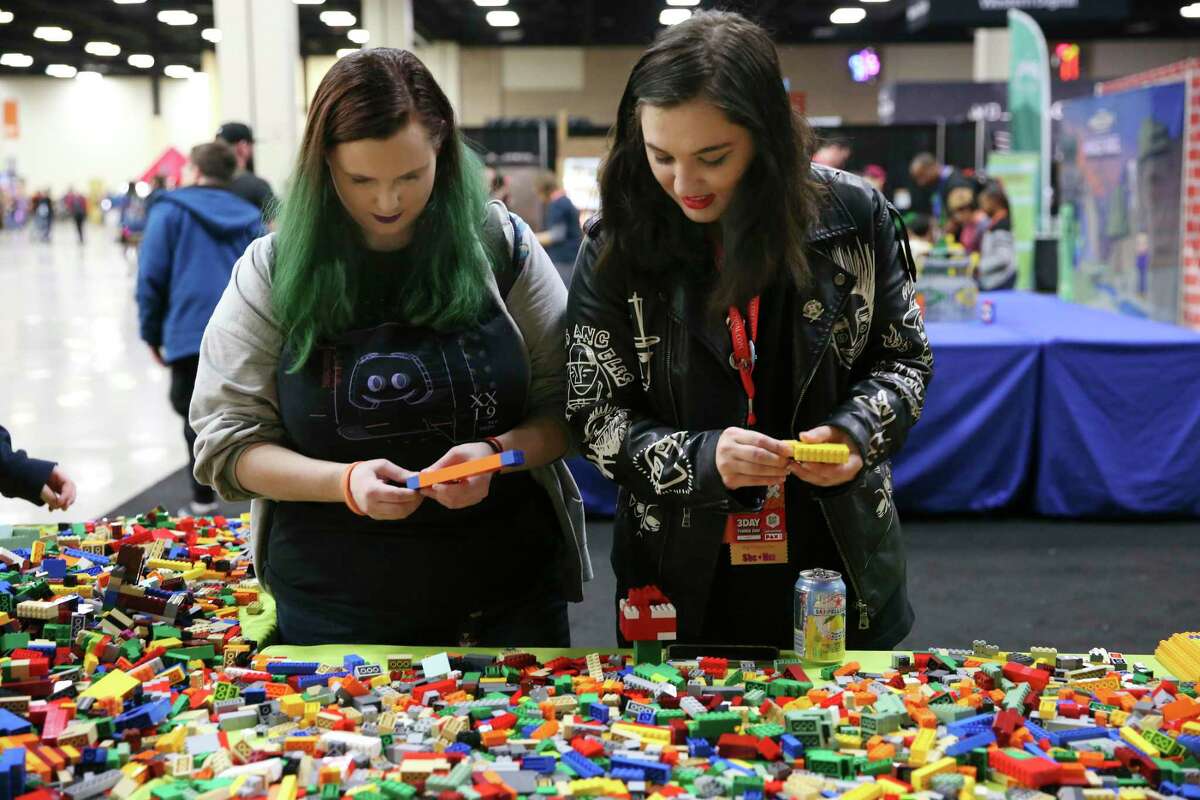 Mariah Dennis, 21, left, and April Marble, 24, try their hands with Legos in the Minefaire exhibit at the 2019 PAX South.