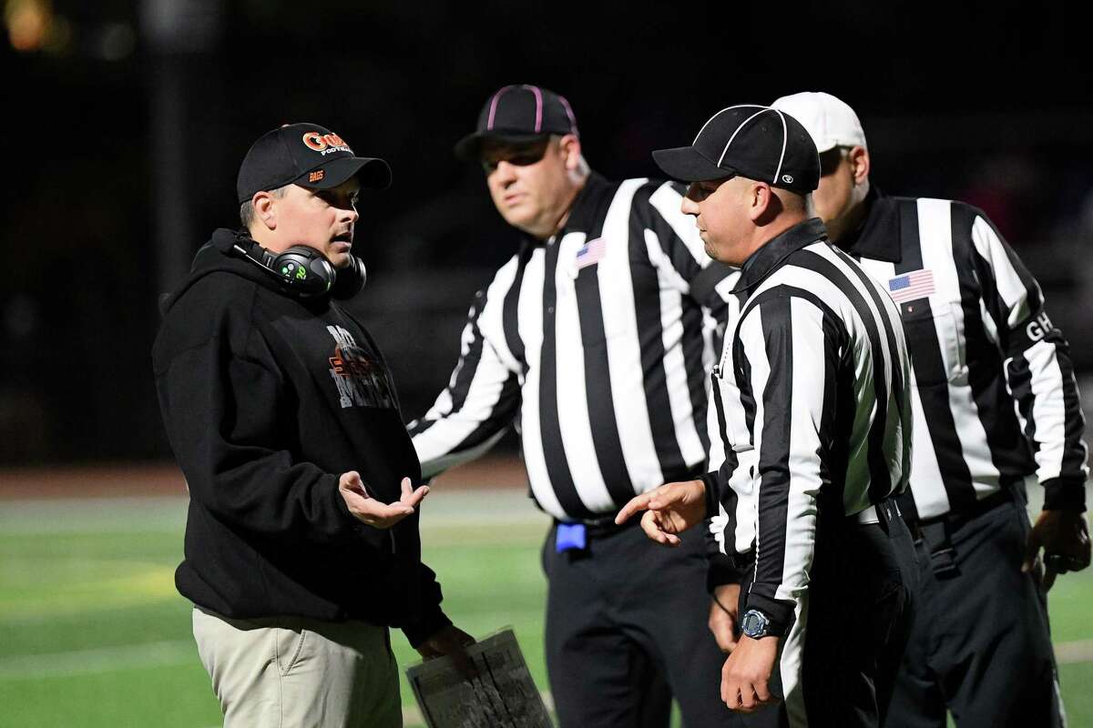 Shelton football coach Mike DeFelice talks with officials during game with Newtown.