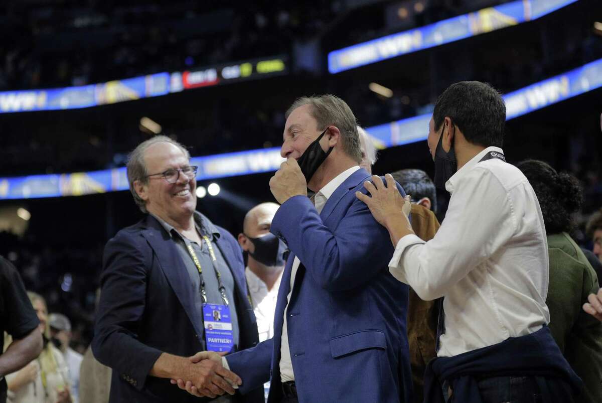 It’s possible that Warriors owner Joe Lacob (center) gets involved with bringing the WNBA to the Bay Area.