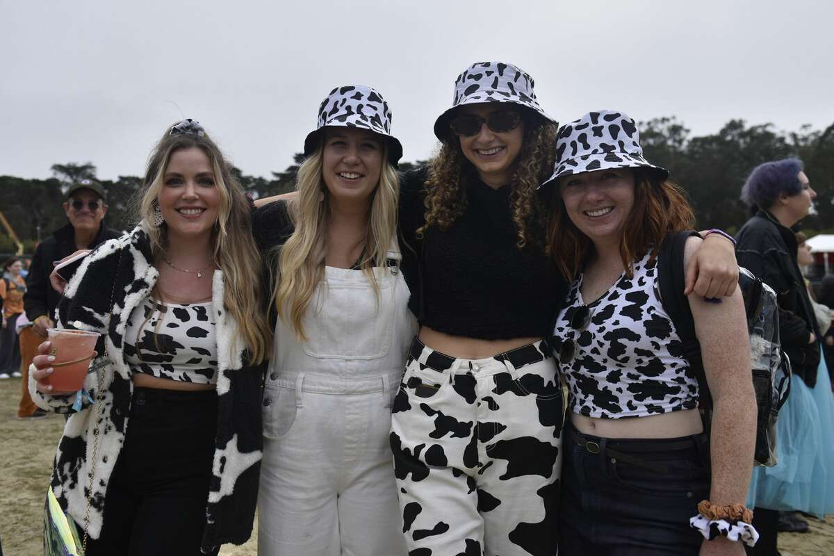 Laura Helmstetter (far left) joins her friends all wearing cow print-themed outfits at Outside Lands, on Saturday, Oct. 29, 2021.
