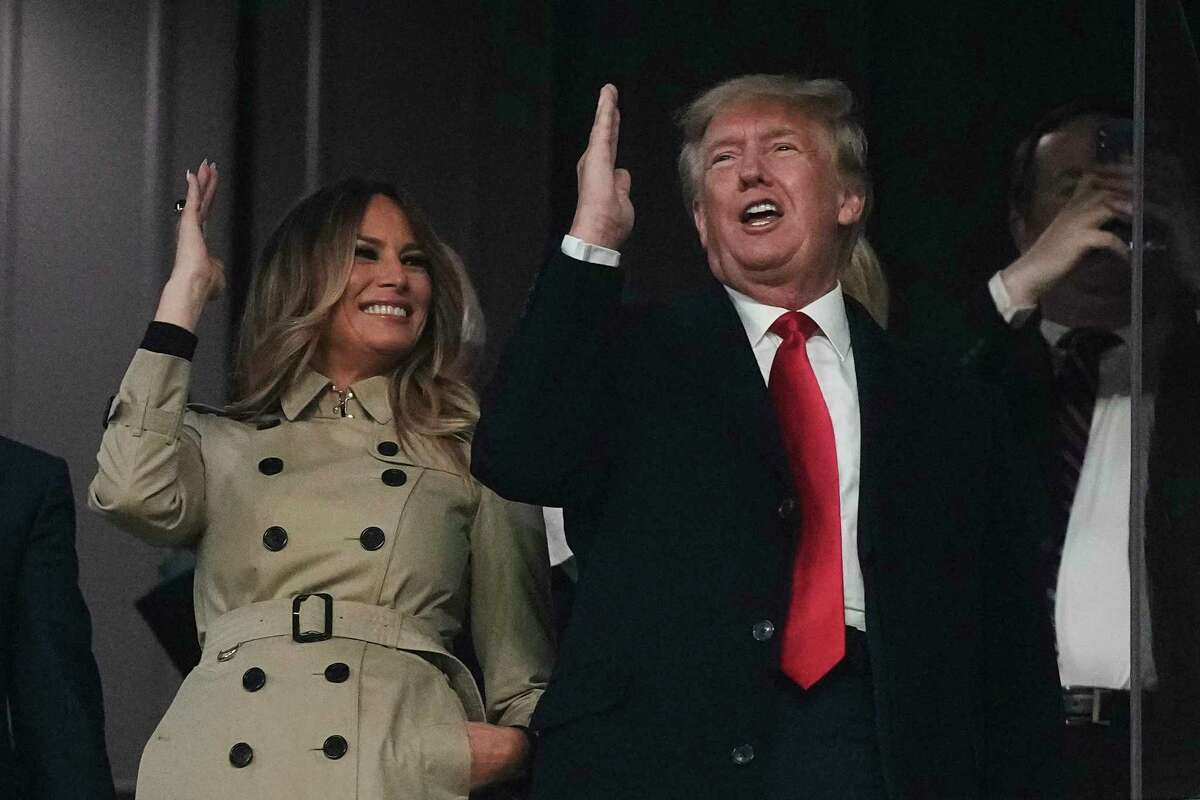 Former President Donald Trump and his wife Melania perform the tomahawk chop before for Game 4 of baseball's World Series between the Houston Astros and the Atlanta Braves Saturday, Oct. 30, 2021, in Atlanta. (AP Photo/David J. Phillip)