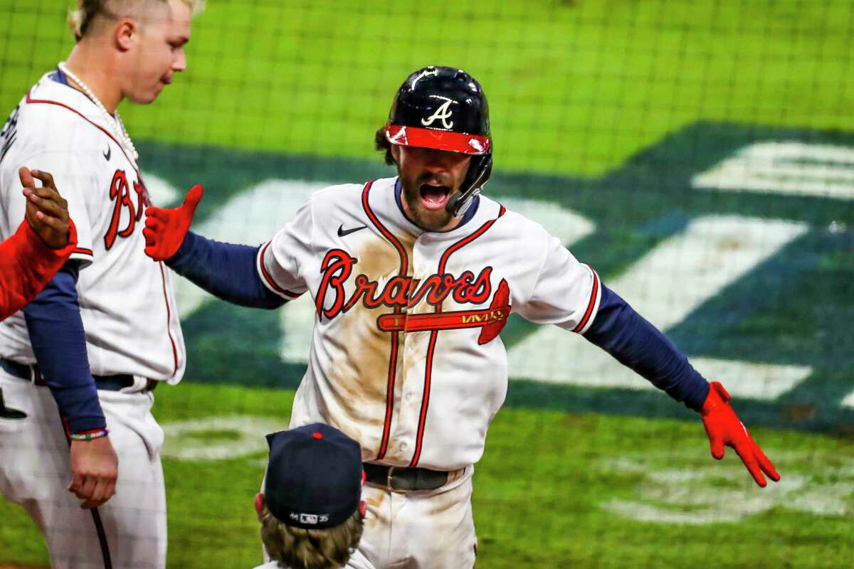 Atlanta Braves shortstop Dansby Swanson (7) celebrates after hitting a solo home run to tie the game 2-2 during the seventh inning of Game 4 of the World Series on Saturday, Oct. 30, 2021 at Truist Park in Atlanta.