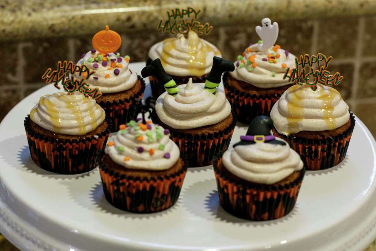 A sampling of Halloween-themed pumpkin spice cupcakes made by sisters Eliza, 16, and Hena Abdul, 13, are displayed in their home kitchen Saturday, Oct. 23. The sisters made the cake and cinnamon cheesecake frosting from scratch before decorating the cupcakes together.