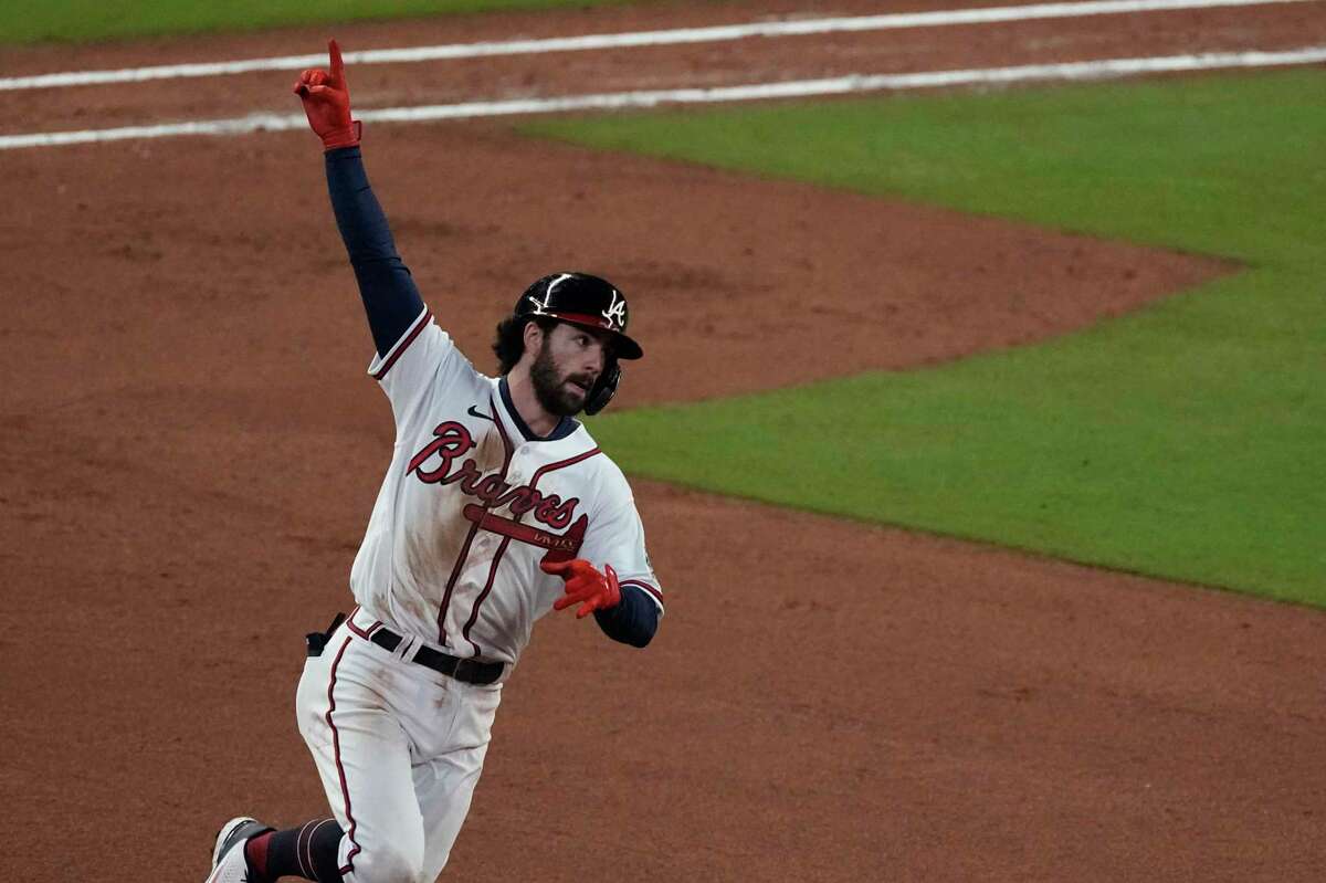 Atlanta Braves' Dansby Swanson celebrates his home run during the seventh inning in Game 4 of baseball's World Series between the Houston Astros and the Atlanta Braves Saturday, Oct. 30, 2021, in Atlanta. (AP Photo/John Bazemore)