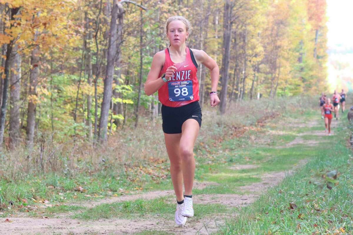 Mylie Kelly races through the woods on her way to a new school record at cross country regionals on Oct. 30, 2021.