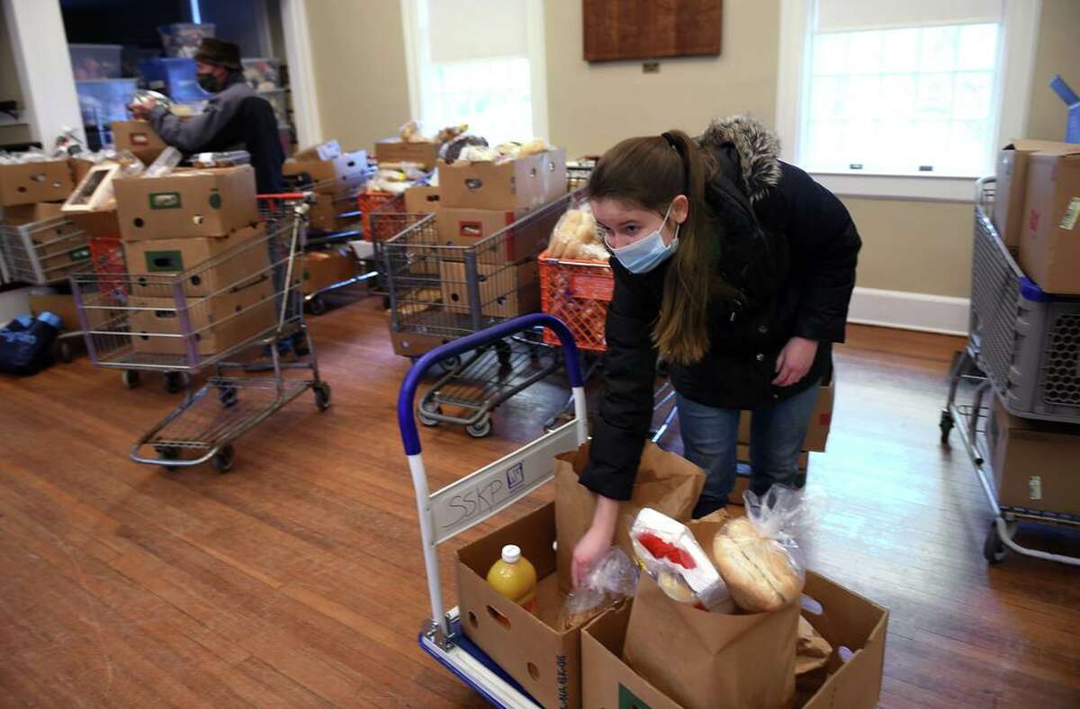 Clare Kenny of Old Lyme prepares bags of groceries at a Shoreline Soup Kitchens & Pantries location at the First Congregational Church in Old Lyme in February, 2021.