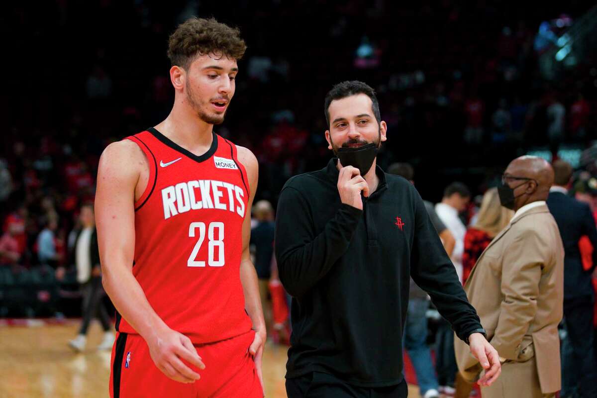 Translater Orhun Gungoren, right, walks off of the court with Houston Rockets center Alperen Sengun (28) after the Rockets lose to the Utah Jazz on Thursday, Oct. 28, 2021, at Toyota Center in Houston.
