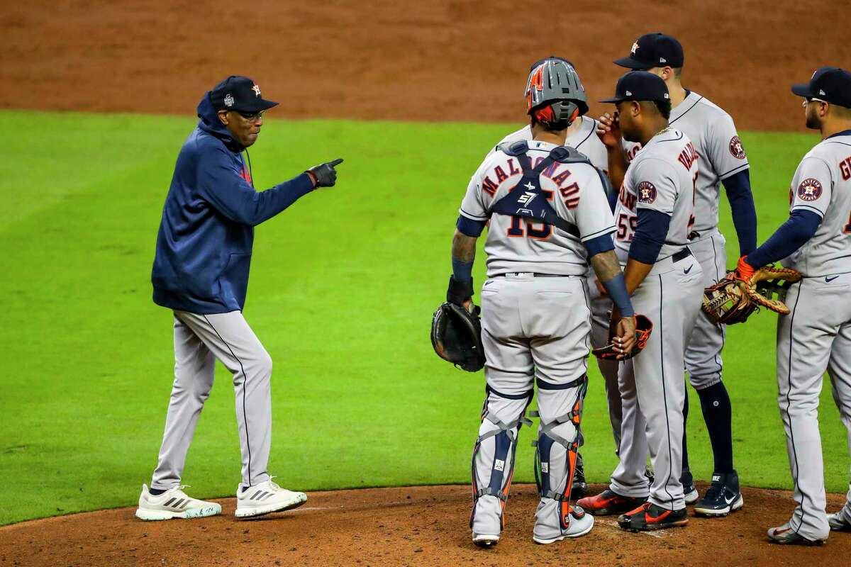 Astros starting pitcher Framber Valdez (59) is pulled by manager Dusty Baker Jr., left, during the third inning of Game 5 of the World Series on Sunday in Atlanta.