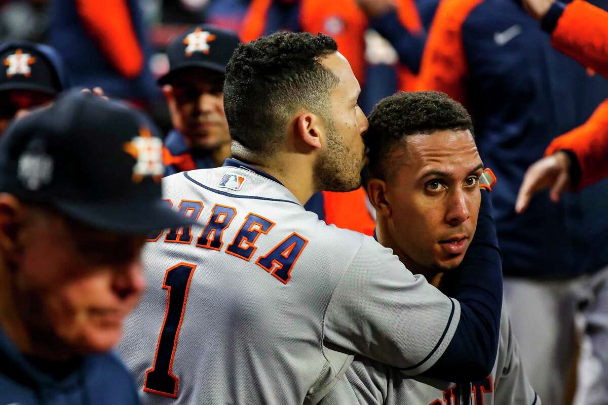 Astros shortstop Carlos Correa (1) embraces Michael Brantley after he helped move over an insurance run.