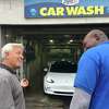 Mark Curtis, left, founder and CEO of Splash Car Wash, at left, is shown at the Darien location.