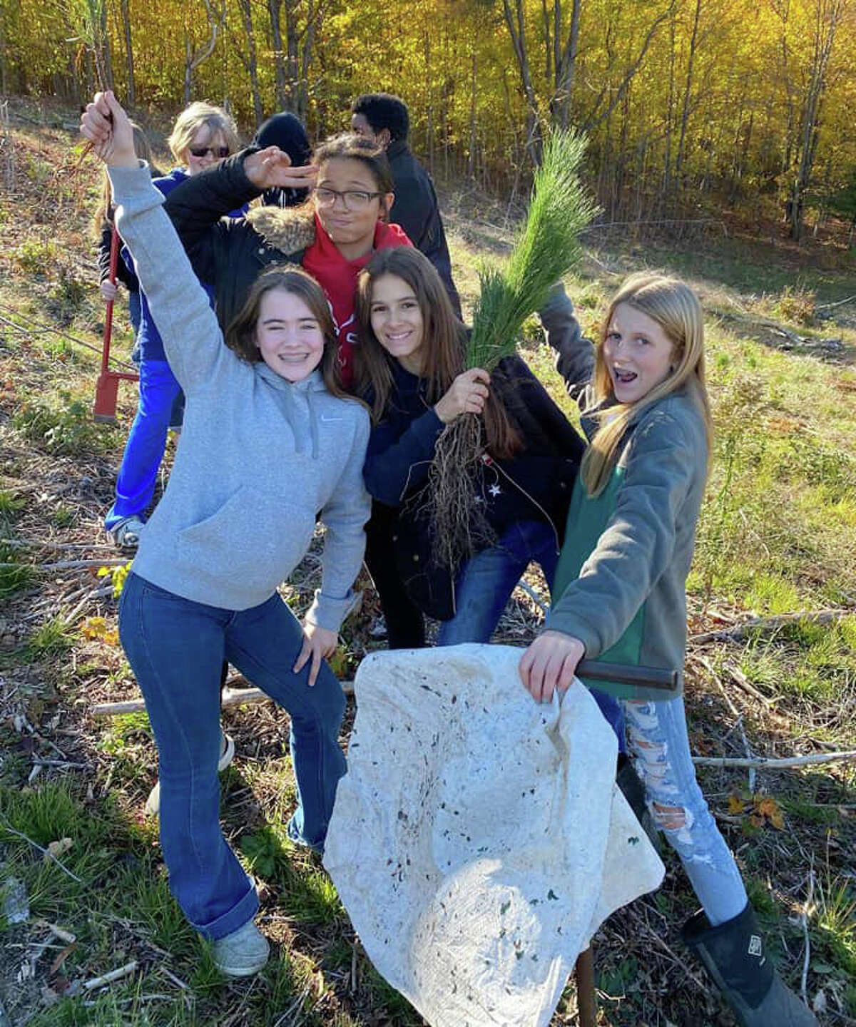 After finishing a lot of hard work, a group of Reed City eighth graders share a smile with the camera. Together, the students planted 1,000 trees. 