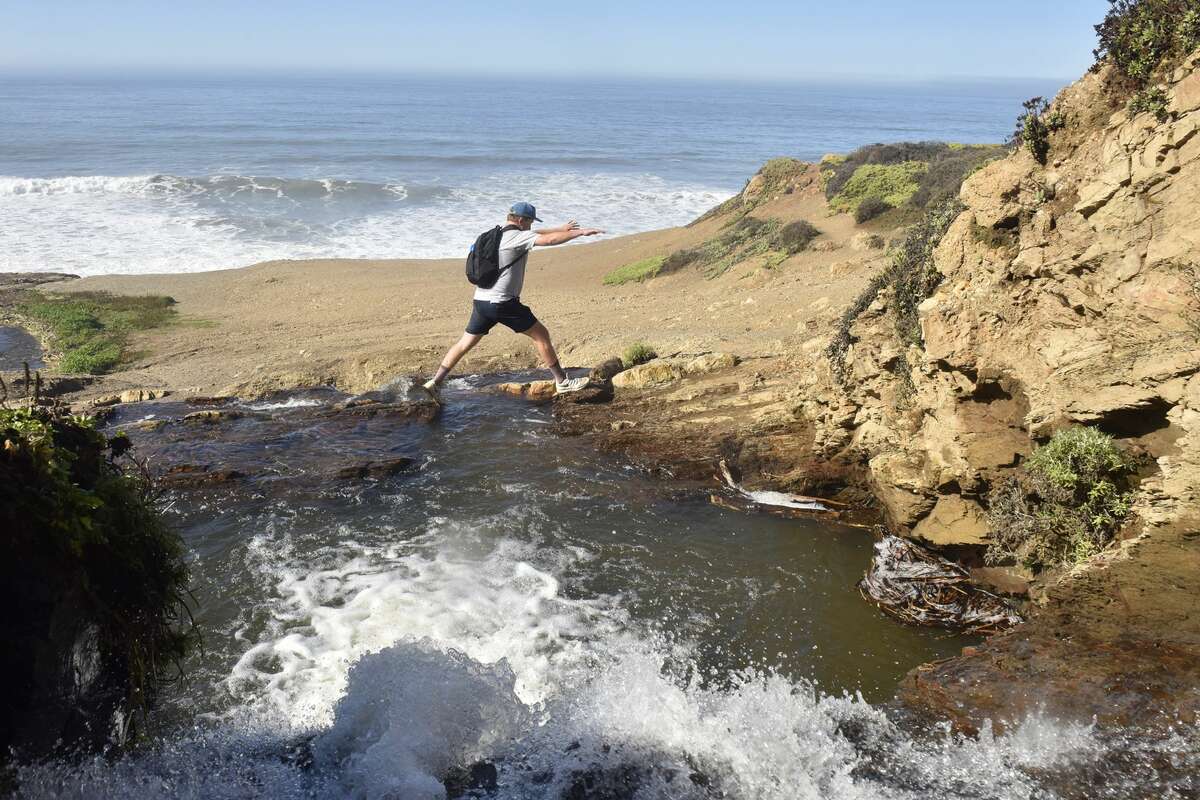 SFGATE editor in chief Grant Marek traverses a stream leading to Alamere Falls in Marin, CA, on Thursday, Oct. 28, 2021.