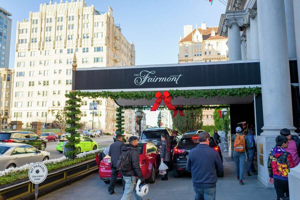 Guests approach the entrance to the iconic Fairmont Hotel on Nob Hill in San Francisco, December 25, 2018.