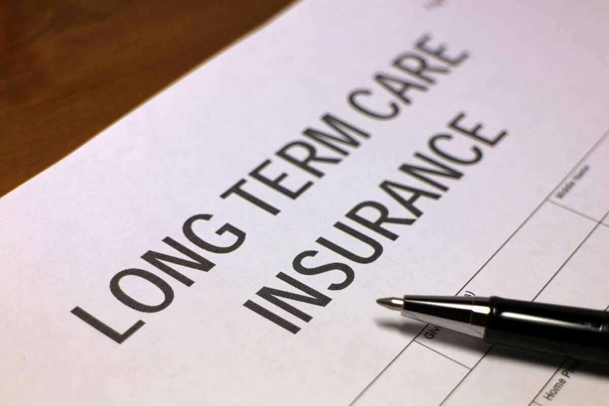 Someone filling out Long Term Care Insurance Form.