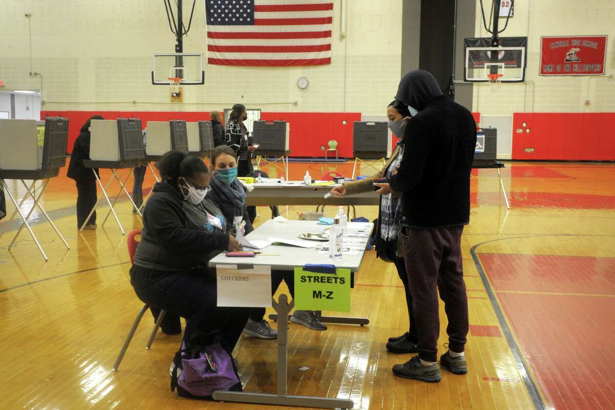 Voters check in to vote on Election Day 2020 at Central High School, in Bridgeport, Conn. Nov. 3, 2020.