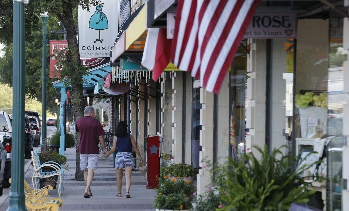 A couple walks through downtown Boerne on Friday, July 21, 2017. 