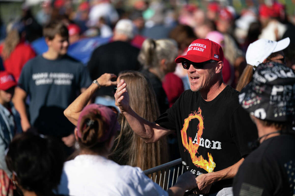 PERRY, GA - SEPTEMBER 25: A man wearing a QAnon t-shirt waits in line for a rally featuring former President Donald Trump on September 25, 2021 in Perry, Georgia. Republican Senate candidate Herschel Walker, Georgia Secretary of State candidate Rep. Jody Hice (R-GA), and Georgia Lieutenant Gubernatorial candidate State Sen. Burt Jones (R-GA) are also scheduled to appear as guests at the rally. (Photo by Sean Rayford/Getty Images)