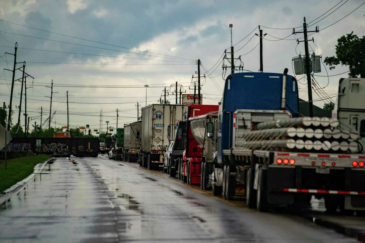 Trucks are backing up on Clinton Drive while waiting for a train to pass on Tuesday, June 29, 2021, at Galena Park.  Cruz Hinojosa, who volunteers with the Environmental Community Advocates of Galena Park group, tried to bring more fresh food to the community with a farmers market, but ran into roadblocks in the small community surrounded by heavy industries.