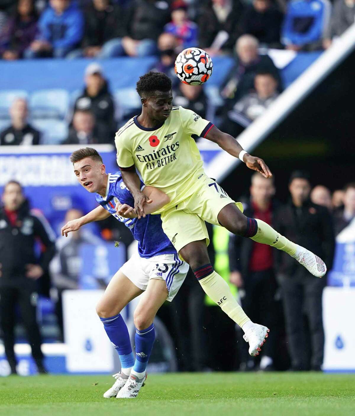 Leicester City's Luke Thomas, left and Arsenal's Bukayo Saka battle for the ball, during the English Premier League soccer match between Leicester City and Arsenal, at the King Power Stadium, in Leicester, England, on Saturday, Oct. 30, 2021. The game was carried on Stamford-based NBC Sports’ NBCSN channel, which will shut down on Dec. 31, 2021. NBC Sports will continue its Premier League coverage on the cable USA Network and other NBCUniversal platforms.