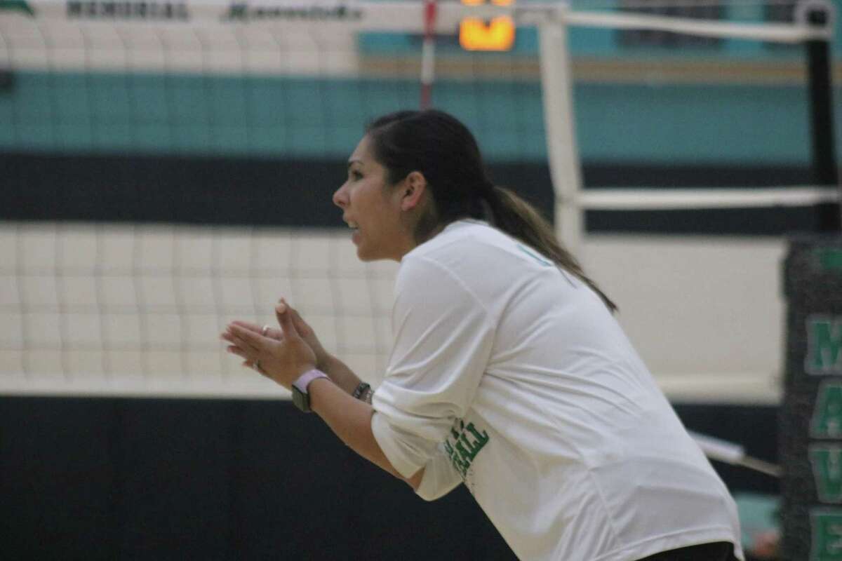 Pasadena High School volleyball head coach Carmen Martinez applauds a good play during a district match. Martinez has the Lady Eagles in the playoffs for the first time since 1990.