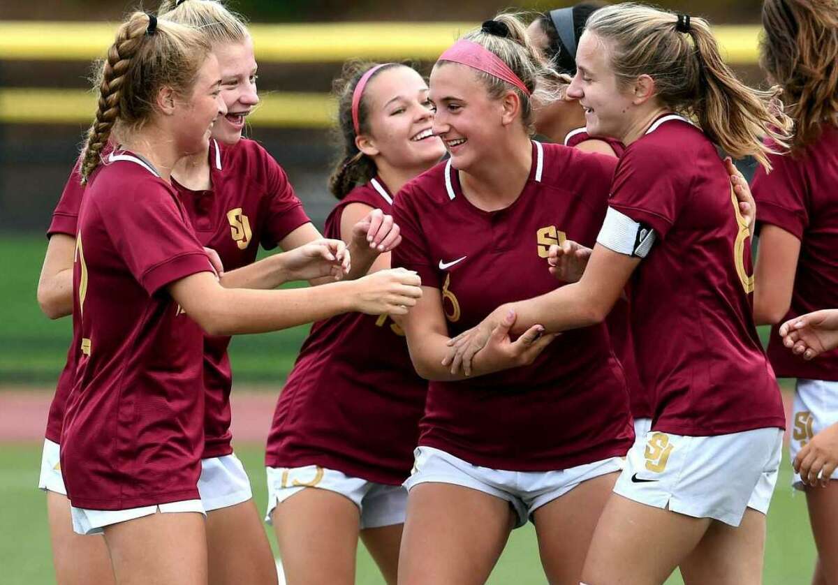Mary Lundregan is congratulated by teammates after St. Joseph went ahead 1-0 against Wilton.