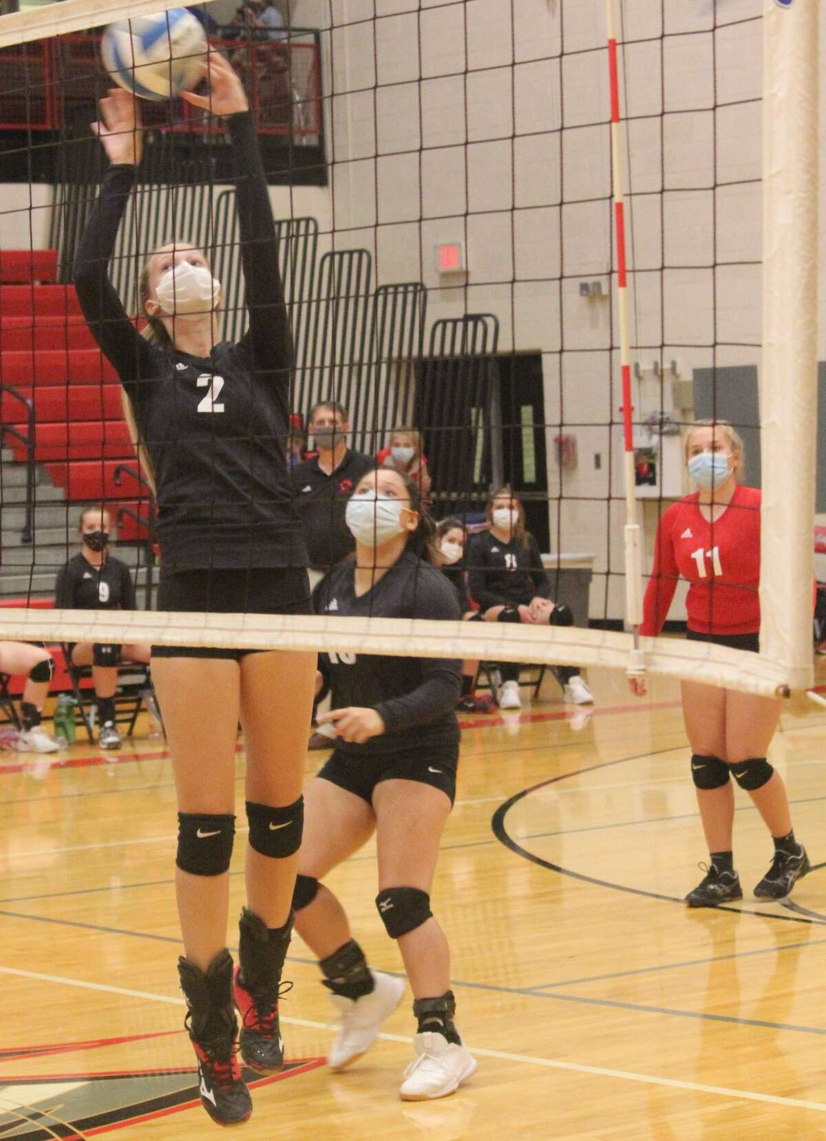 Kyleigh Weck works with the ball at the net for the Reed City volleyball team.