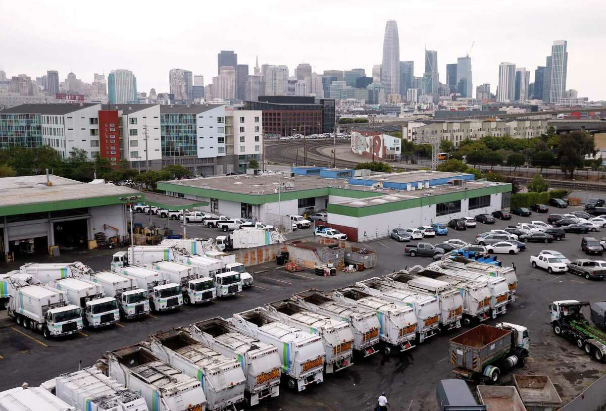 Recycling collection trucks are parked in a maintenance yard on 7th Street in San Francisco. A grieving wife has sued the San Francisco waste company where her husband worked as a financial controller, alleging the executives held a hostile “inquisition” that drove him to kill himself.