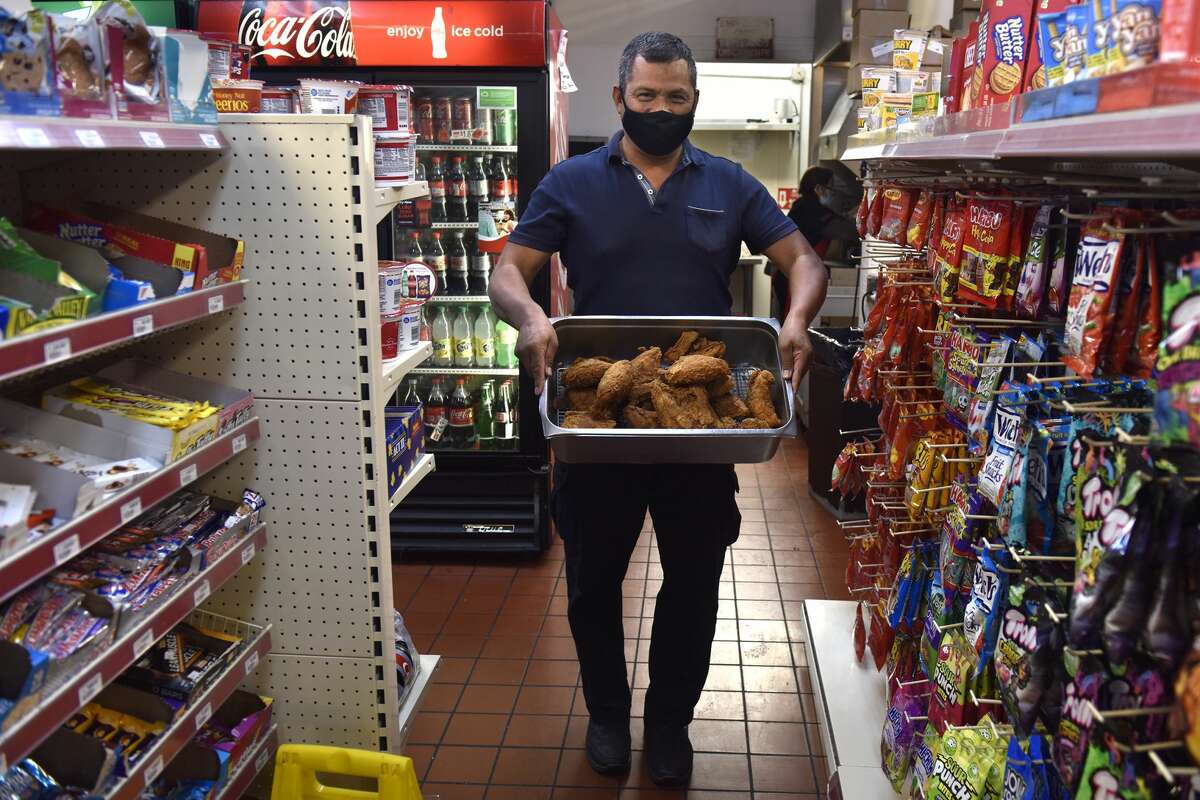 Gas and shop manager José M. Guillen will be walking through the station's convenience store with a fresh batch of Krispy Krunchy Chicken on Tuesday, November 2, 2021.