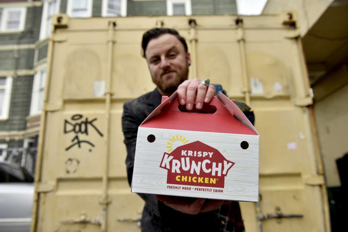 Stuart Schuffman, AKA Broke Ace Stuart, shows an eight-piece box of Krispy Krunchy Chicken from the Gas and Shop on South Van Ness Avenue in San Francisco on Tuesday, November 2, 2021.