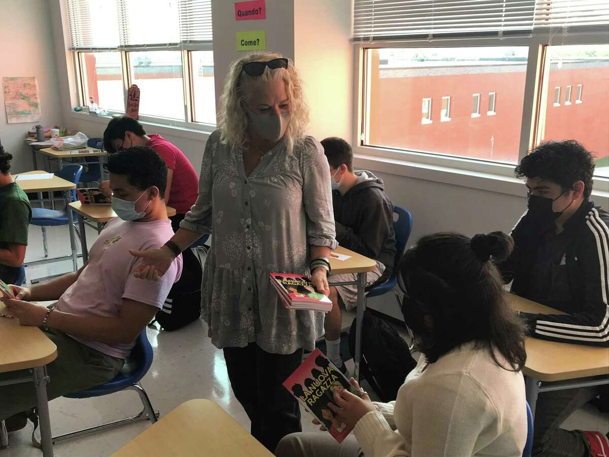 Author Jennifer Degenhardt hands out copies of her book, translated into Italian by West Haven High School students, to the translators Oct. 8, 2021.