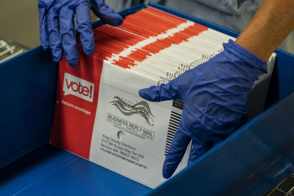 RENTON, WA - AUGUST 04: An elections worker sorts unopened ballots at the King County Elections headquarters on August 4, 2020 in Renton, Washington. Today is election day for the primary in Washington state, where voting is done almost exclusively by mail. (Photo by David Ryder/Getty Images)