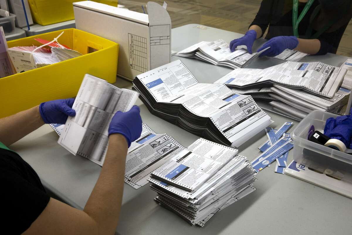 King County Elections workers process ballots at King County Elections headquarters on Nov. 3, 2020, in Renton, Wash.