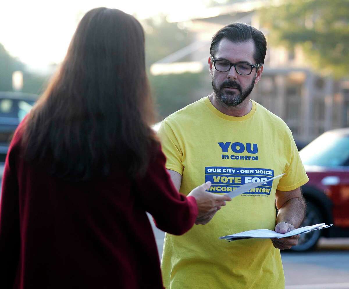 Alex Bunch speaks to a voter in favor of incorporation as residents take to the polls to decide whether or not The Woodlands should become a city, Tuesday, Nov. 2, 2021, in The Woodlands.