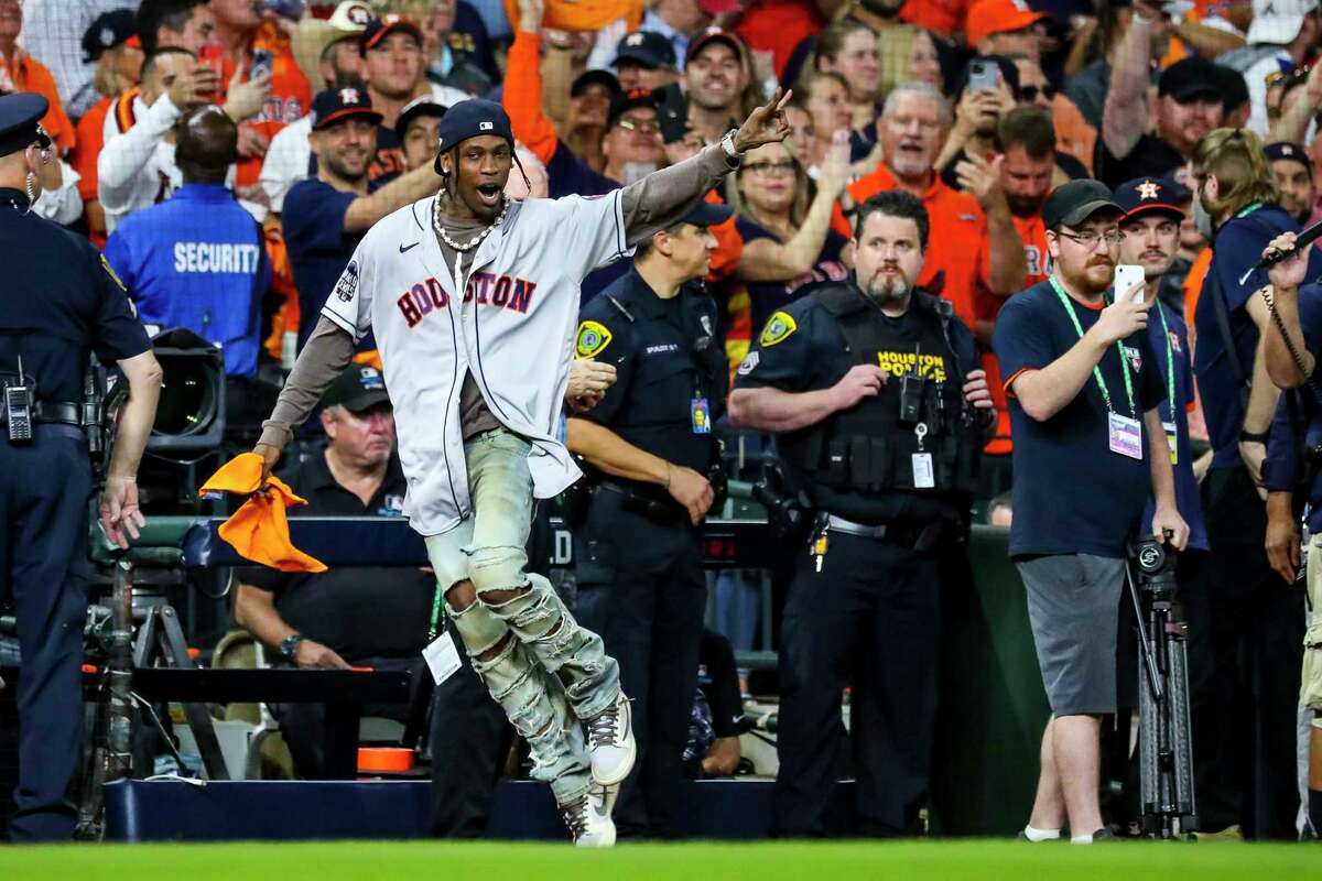 Travis Scott runs across the field after making the "Play Ball" call before Game 6 of the World Series on Tuesday, Nov. 2, 2021 at Minute Maid Park in Houston.