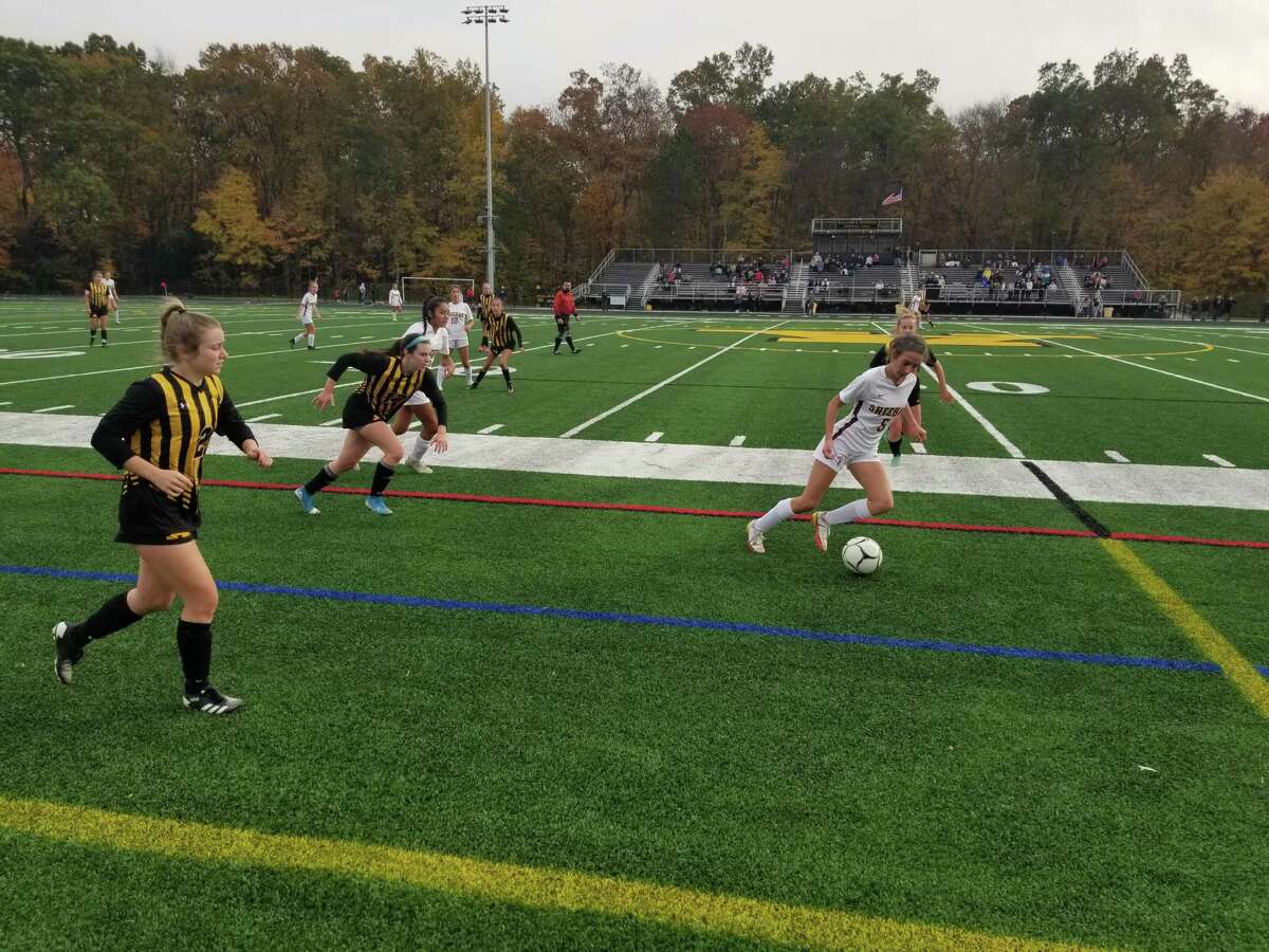 Sheehan’s Olivia Platt takes it up the field with Amity defenders trailing behind during Amity’s 4-1 victory at Johnson Field in the SCC tournament semifinals on Wednesday.