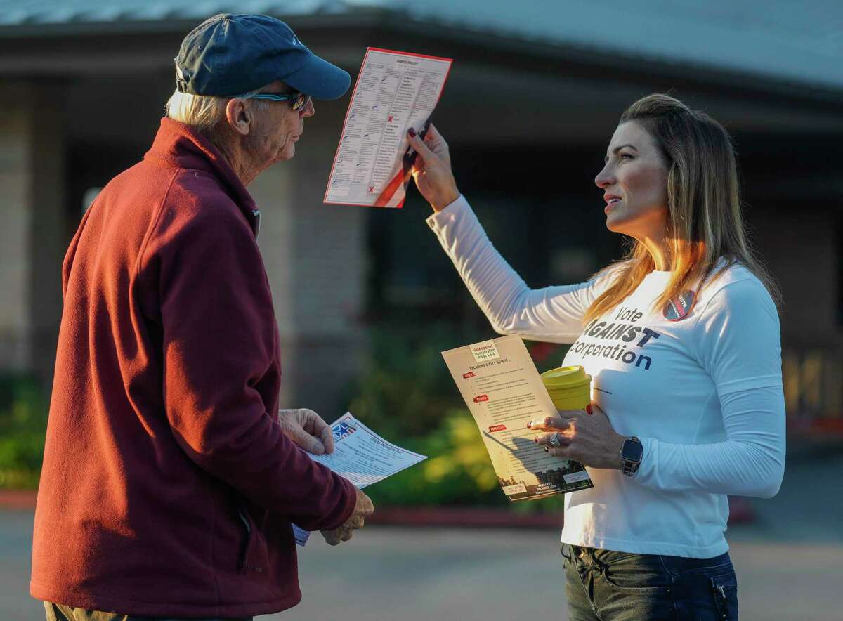 Hannah Wilner, right, speaks to a voter against incorporation Nov. 2 as residents take to the polls to decide whether or not The Woodlands should become a city.