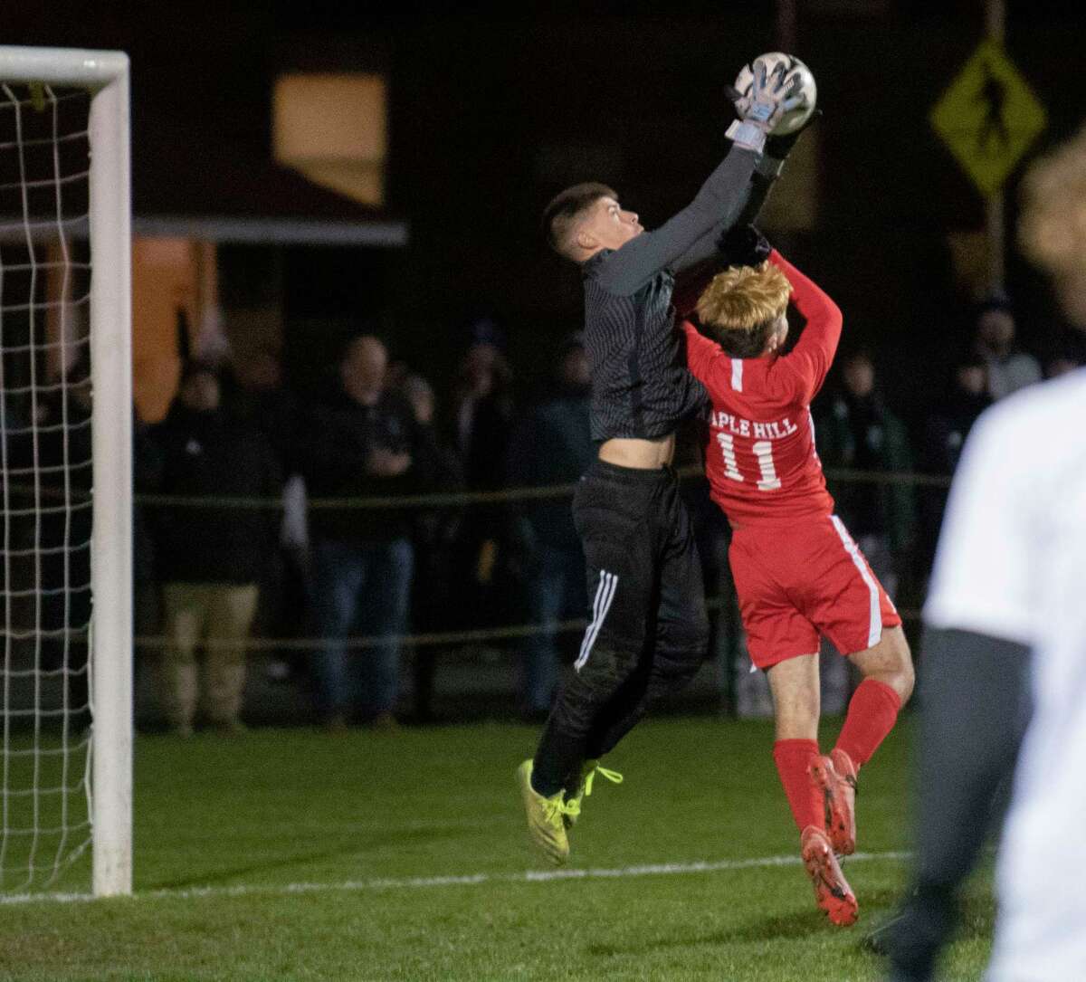 Mayfield goalie Aiden Martuscello makes a save as Maple Hill’s Hamilton Davids tries to score during the Class C boys' soccer final on Tuesday, Nov. 2, 2021 in Colonie, N.Y.