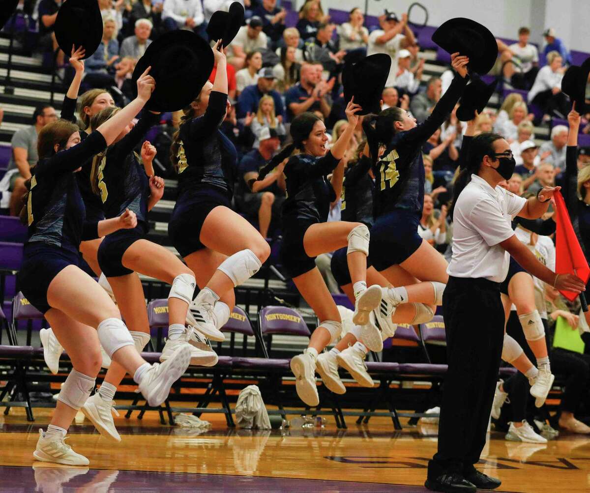 Lake Creek players celebrate back-to-back aces with cowboy hats in hand during the first set of a Region III-5A bi-district volleyball playoff match at Montgomery High School, Tuesday, Nov. 2, 2021, in Montgomery.