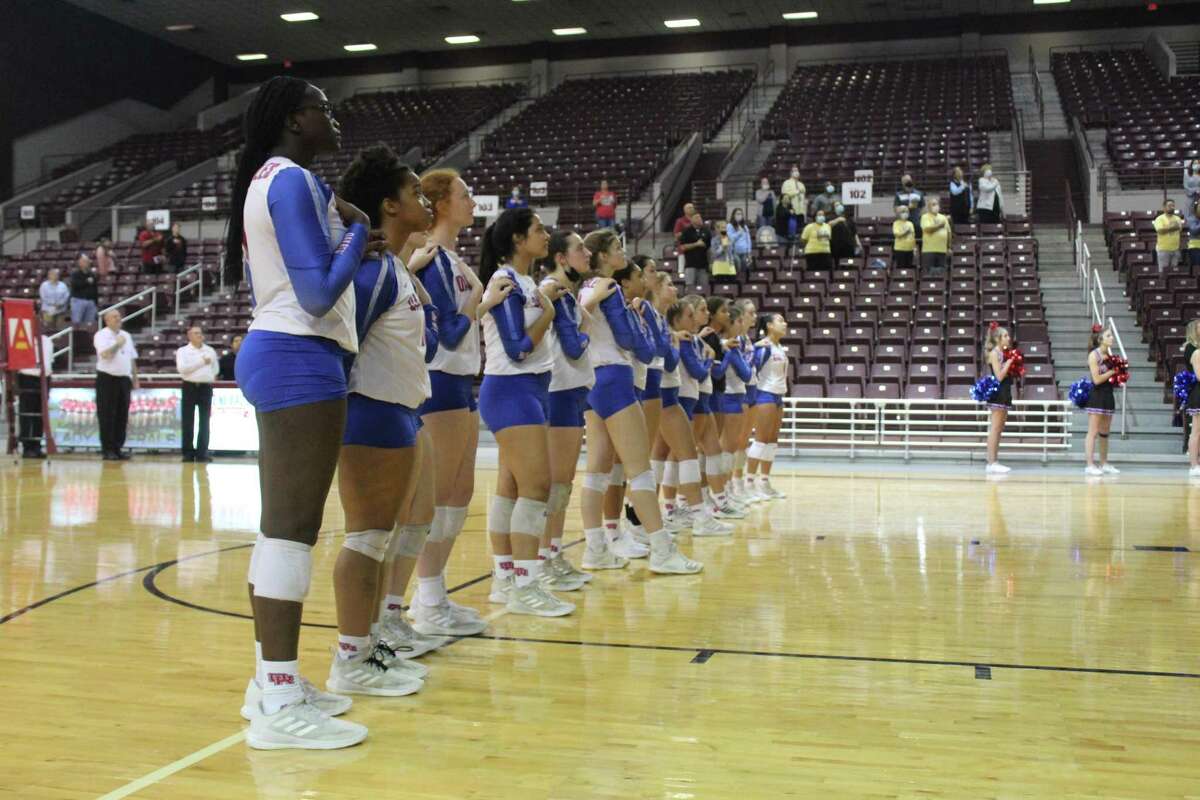 The Oak Ridge Lady War Eagles face the American flag during the national anthem at the Campbell Center in Aldine.