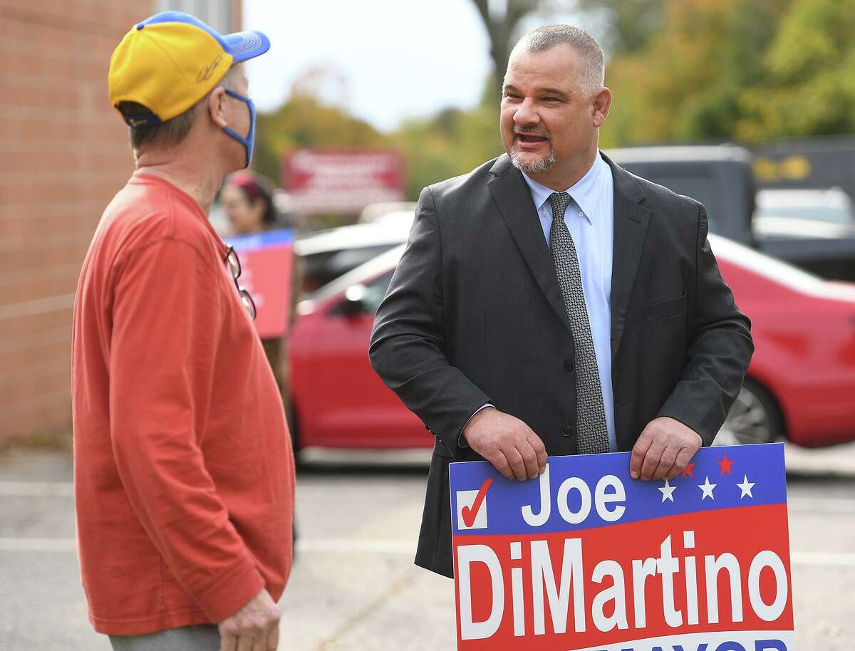 Derby Democratic candidate for mayor Joe DiMartino talks with a voter outside the polls at Bradley School in Derby, Conn. on Tuesday, November 2, 2021.