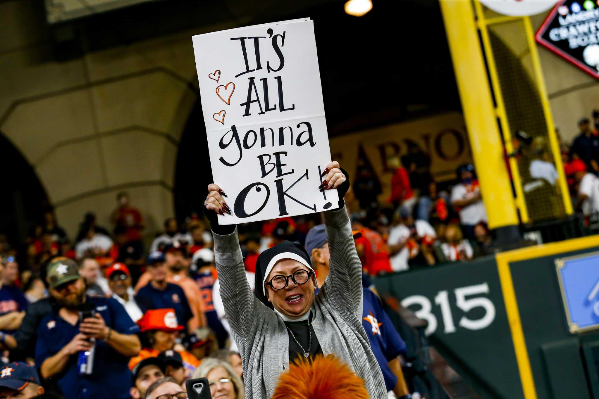 A Atlanta Braves fan does the tomahawk chop cheer during the first inning  in Game 3 of baseball's World Series between the Houston Astros and the  Atlanta Braves Friday, Oct. 29, 2021