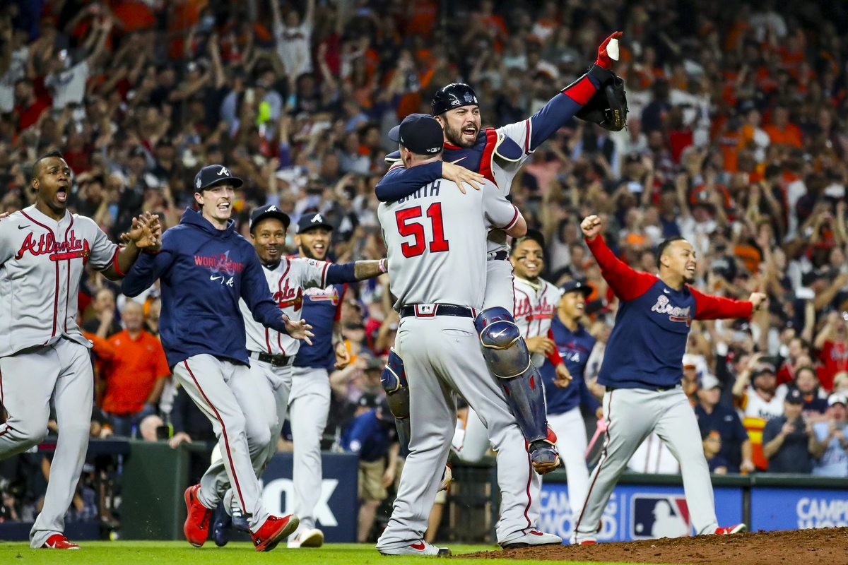 Atlanta Braves relief pitcher Will Smith (51) picks up Atlanta Braves catcher Travis d'Arnaud (16) as the Atlanta Braves celebrate their World Series title with a 7-0 win of Game 6 of the World Series on Tuesday, Nov. 2, 2021 at Minute Maid Park in Houston.
