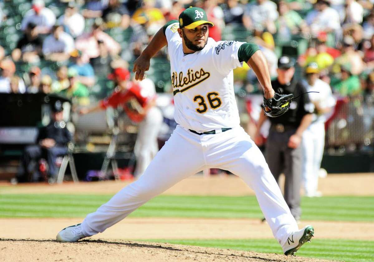 OAKLAND, CA - MARCH 29: Oakland Athletics relief pitcher Yusmeiro Petit (36) throws in motion to deliver a pitch during opening day regular season game between the Oakland Athletics and the Los Angeles Angels on March 29, 2018 at O.co Coliseum in Oakland,CA (Photo by Samuel Stringer/Icon Sportswire via Getty Images)