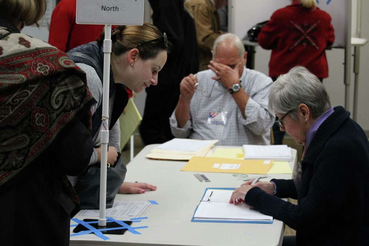 A voter checks in at the Westport Public Library polling station on Nov. 8, 2016 in Westport, CT.