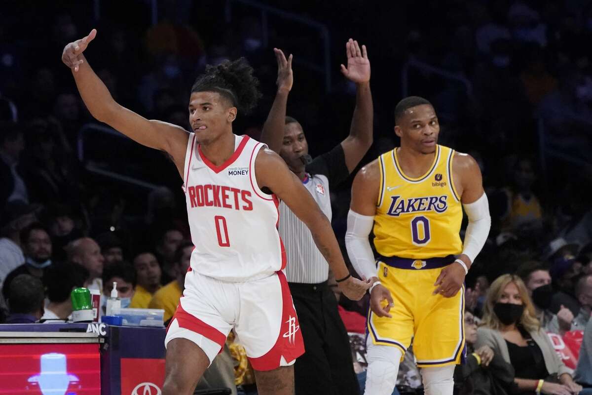 Houston Rockets guard Jalen Green, left, gestures after a making a three-point basket next to Los Angeles Lakers guard Russell Westbrook during the first half of an NBA basketball game Tuesday, Nov. 2, 2021, in Los Angeles.