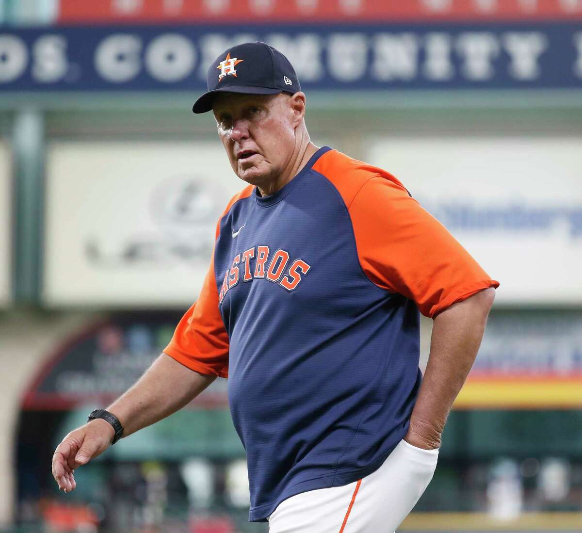 Houston Astros pitching coach Brent Strom (56) walks to the dugout without a mask before the start of an MLB baseball game at Minute Maid Park, Monday, May 10, 2021, in Houston.