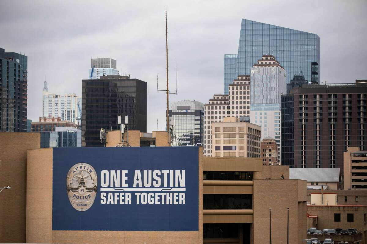 The Austin Police Department building with the Austin skyline in the background on March 22, 2021.