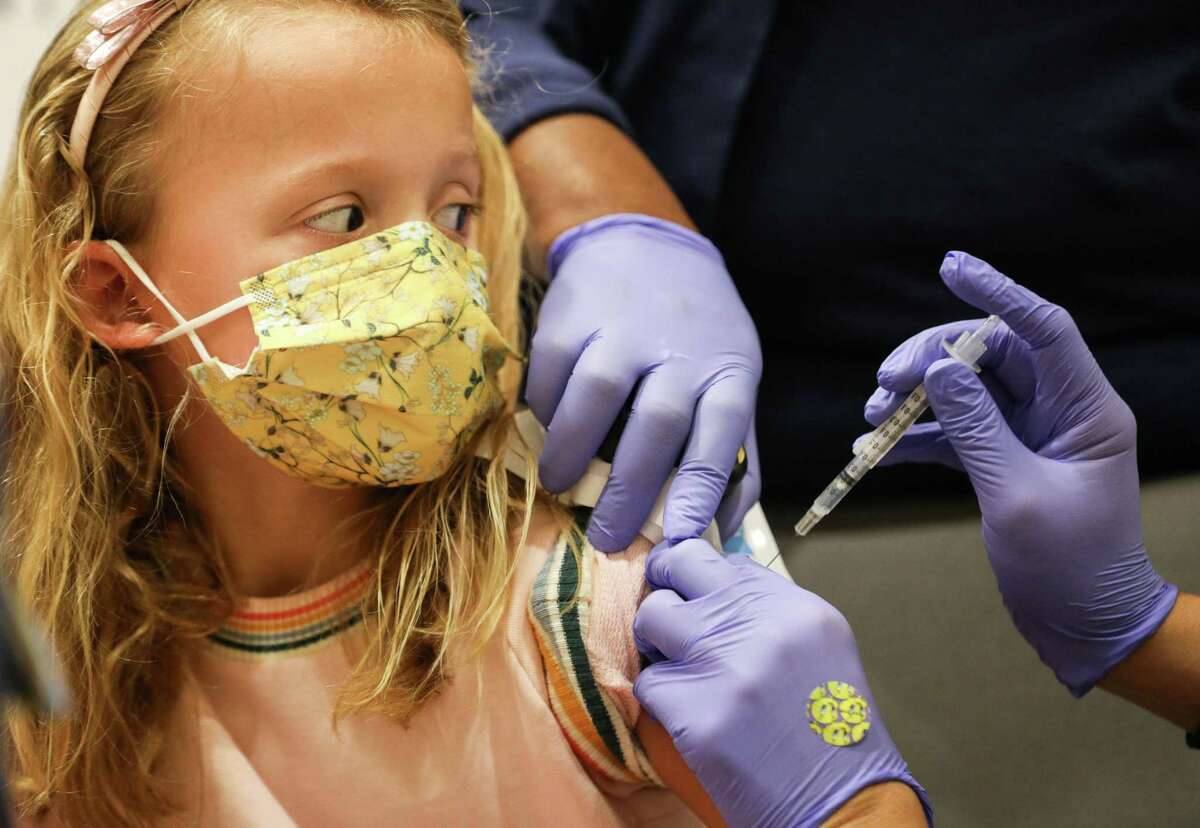 Haiden Ellsworth, 7, watches as she gets the Pfizer pediatric COVID-19 vaccine Wednesday, Nov. 3, 2021, at Children’s Memorial Hermann Hospital in Houston.